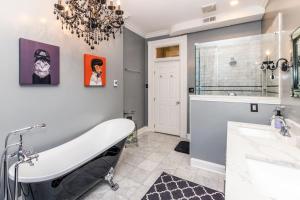 a bathroom with a bath tub and a sink and a tub at Luxury Brownstone - Walk to ALL - Washington Park in Cincinnati +60 photos