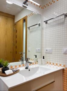 a bathroom with a white sink and a mirror at Las Terrazas de Vigo - Paula in Vigo +16 photos