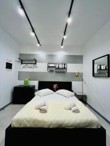 a bedroom with a large bed with two towels on it at Poseidon Suite by Zeussuites in Athens