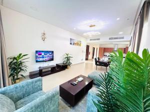 a living room with a couch and a table at Aspire Tower-The Tranquil Haven in Manama