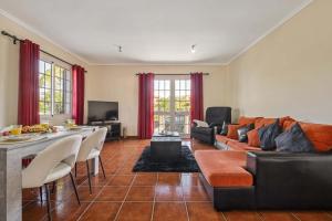 a living room with a couch and a table at Palm Tree House by Homie in Ponta Delgada