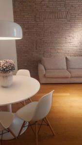 a living room with a table and chairs and a couch at Dimora Farini in Modena