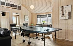 a room with a ping pong table and chairs at Cozy Home In Harboøre With Kitchen in Langerhuse