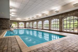 a swimming pool with windows in a building at Holiday Inn Express Hotel & Suites Hagerstown by IHG in Hagerstown