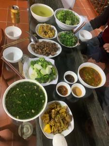 a table with many bowls of food on it at Ba Be Retreat in Nà Dzương