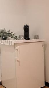 a white table with a pot on top of it at La Buhardilla de Tuy in Tui +7 photos