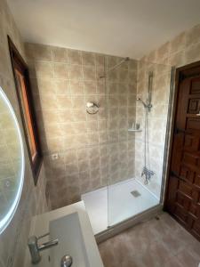 a bathroom with a shower with a glass door at Beach Appartement Denia in Denia +4 photos