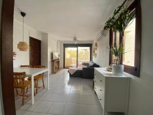 a kitchen and living room with a table and a couch at Beach Appartement Denia in Denia
