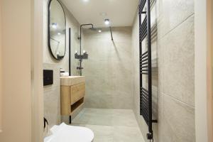 a bathroom with a shower and a toilet and a sink at Curated apartment near Scheveningen beach in Scheveningen +23 photos