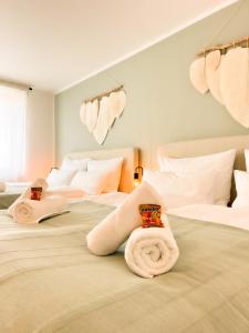a bedroom with two beds with towels on them at I Zentral l Kingsizebetten l nähe HBF und Dom in Aachen
