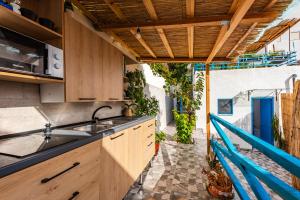 an outdoor kitchen with wooden cabinets and a sink at Central Vila 5 in Durrës