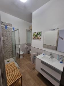 a bathroom with a sink and a shower and a toilet at Pietra Marina in Capaci