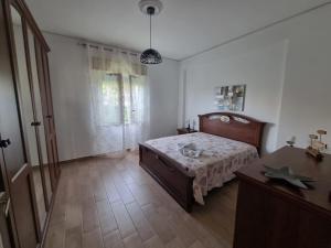 a bedroom with a bed and a table and a window at Pietra Marina in Capaci