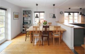 a kitchen and dining room with a table and chairs at Cozy Home In Samsø With Wifi in Kolby Kås