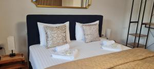 a bed with two towels and pillows on it at aNNa s Cozy Home with Private Forest, Canopy Terrace & Parking, near Red Bull Ring in Sankt Michael in Obersteiermark +48 photos