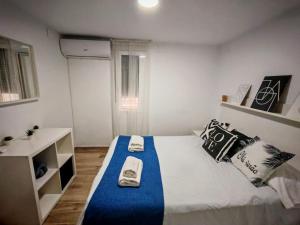 a bedroom with a bed with two towels on it at La Vida es Bella Córdoba in Córdoba