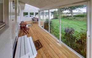 a screened in porch with a table and chairs at 3 Bedroom Beautiful Home In Ljungby in Ljungby