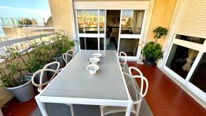 a white table and chairs on a balcony at 2 bedrooms with swimming pool Nomad Dreams N 7 in Cascais