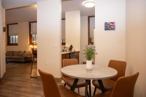 a dining room with a table and chairs and a kitchen at City Hall Clerk's Office in Rochester