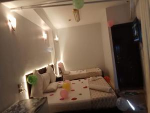 una camera con un letto con palloncini e uno specchio di Abo Elwafa Hotel a Sohag