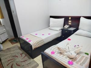 Letto o letti in una camera di Abo Elwafa Hotel