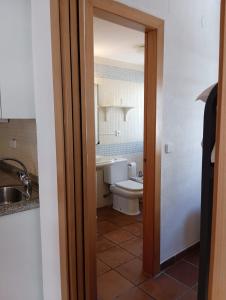 a bathroom with a toilet and a sink at Apartamento con piscina, sauna y jacuzzi edificio Arttyco in Sierra Nevada +24 photos