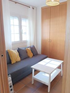 a living room with a couch and a table at Apartamento con piscina, sauna y jacuzzi edificio Arttyco in Sierra Nevada