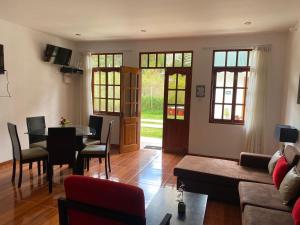 a living room with a table and a couch at Hahn des Felsens in Oxapampa