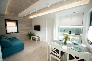 a living room with a table and a blue couch at Mogosa Village in Baia-Sprie