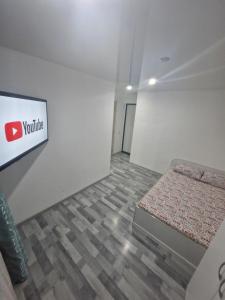 a room with a bed and a sign on the wall at 1-комнатная квартир в центре города Strekoza in Petropavlovsk