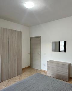 a room with a closet and a dresser and a door at Appartamenti Estivi in Cirò Marina