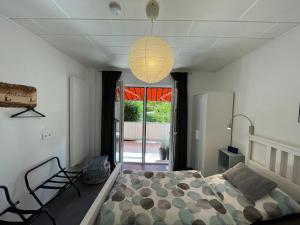 a bedroom with a bed and a chandelier at Pension Braun - Dein Ankerplatz in Löhne