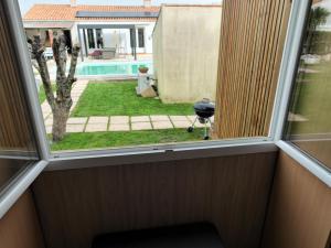 a window in a room with a view of a yard at Greenkub in Avrillé