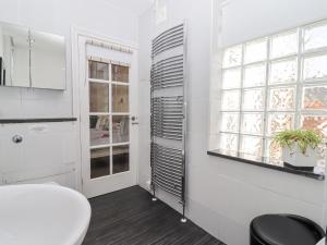 a bathroom with a toilet and a window at Whistler in St Ives +28 photos