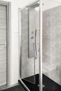 a shower with a glass door in a bathroom at Lingotto Fiere - Parcheggio Privato - A casa di Sara e Sami in Turin