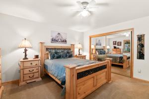 a bedroom with a wooden bed and a mirror at Sugarbear Cabin - Luxurious Log Cabin, Pet Friendly in Sugarloaf