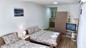 a small room with a bed and a couch at Apartments Tomic in Ohrid