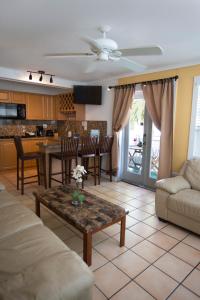 a living room with a couch and a table at Courtney's Place Historic Cottages & Inns in Key West