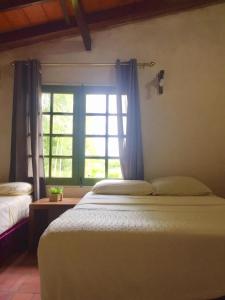 Postelja oz. postelje v sobi nastanitve Posada San Miguel