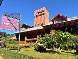 a building with a sign in front of it at Pousada da Baronesa in Nova Petrópolis