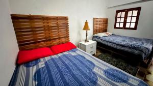 a bedroom with two twin beds and a window at Casa Yoly Hostel Granada in Granada +60 photos