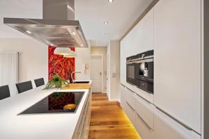 a kitchen with a white counter and a stove top oven at EDLER WOHNRAUM Schwanenteich-Suite mit Balkon, Kaffeevollautomat, Lift & Parkplatz in Zwickau +30 photos