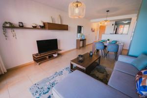 a living room with a couch and a tv and a table at Bonsai in Murcia