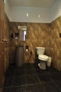 a bathroom with a toilet and a mirror at Kevin Resort in Thang Kwian +71 photos