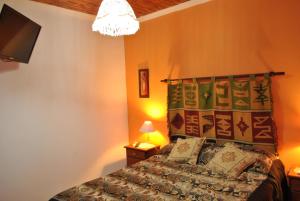 a bedroom with a bed with a quilt on it at Departamentos Betania in Las Grutas