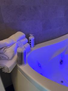 a bathroom with a blue tub with towels on it at Casa Morena in Rome +22 photos