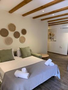 a bedroom with a bed with two towels on it at mangata suite home private pool in Spartokhórion