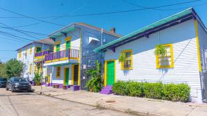 a row of colorful houses on a street at Historic Mardi Gras Inn in New Orleans