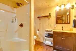 a bathroom with a shower and a sink and a toilet at The Locke-ness Pond Cabin in Chesterville! in Wilton +16 photos