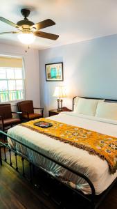 a bedroom with a bed and a ceiling fan at Historic Mardi Gras Inn in New Orleans